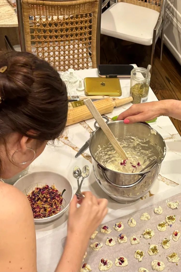 Folding rose petals into cookie batter by hand
