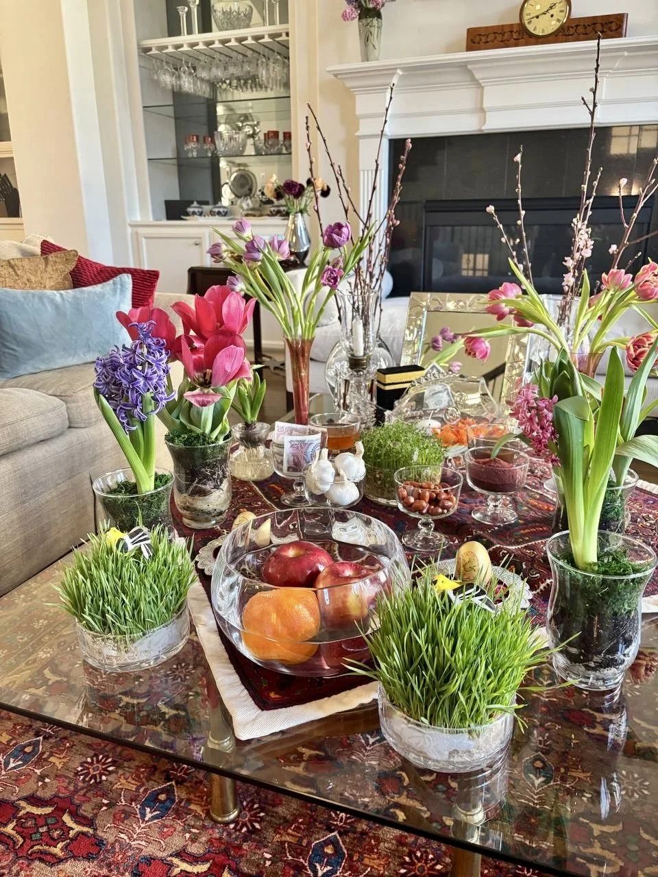 A Nowruz haft-sin table with tulips, hyacinths and wheat grass