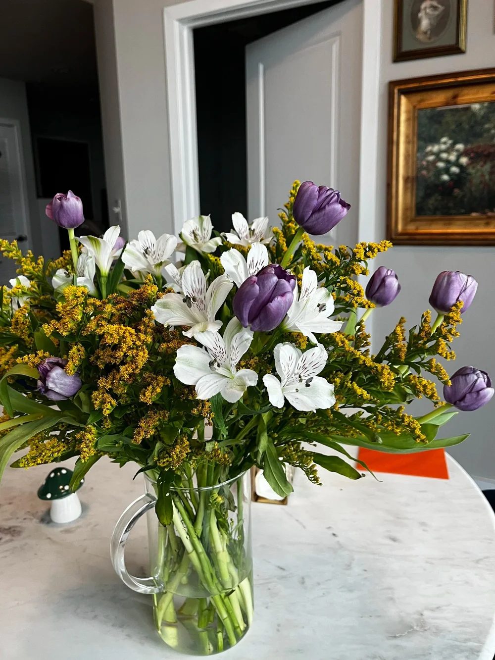 White alstroemeria and purple tulips with sprays of goldenrod