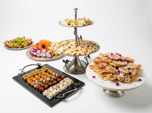 A tiered stand of Persian pastries, baklava and rose-topped cookies